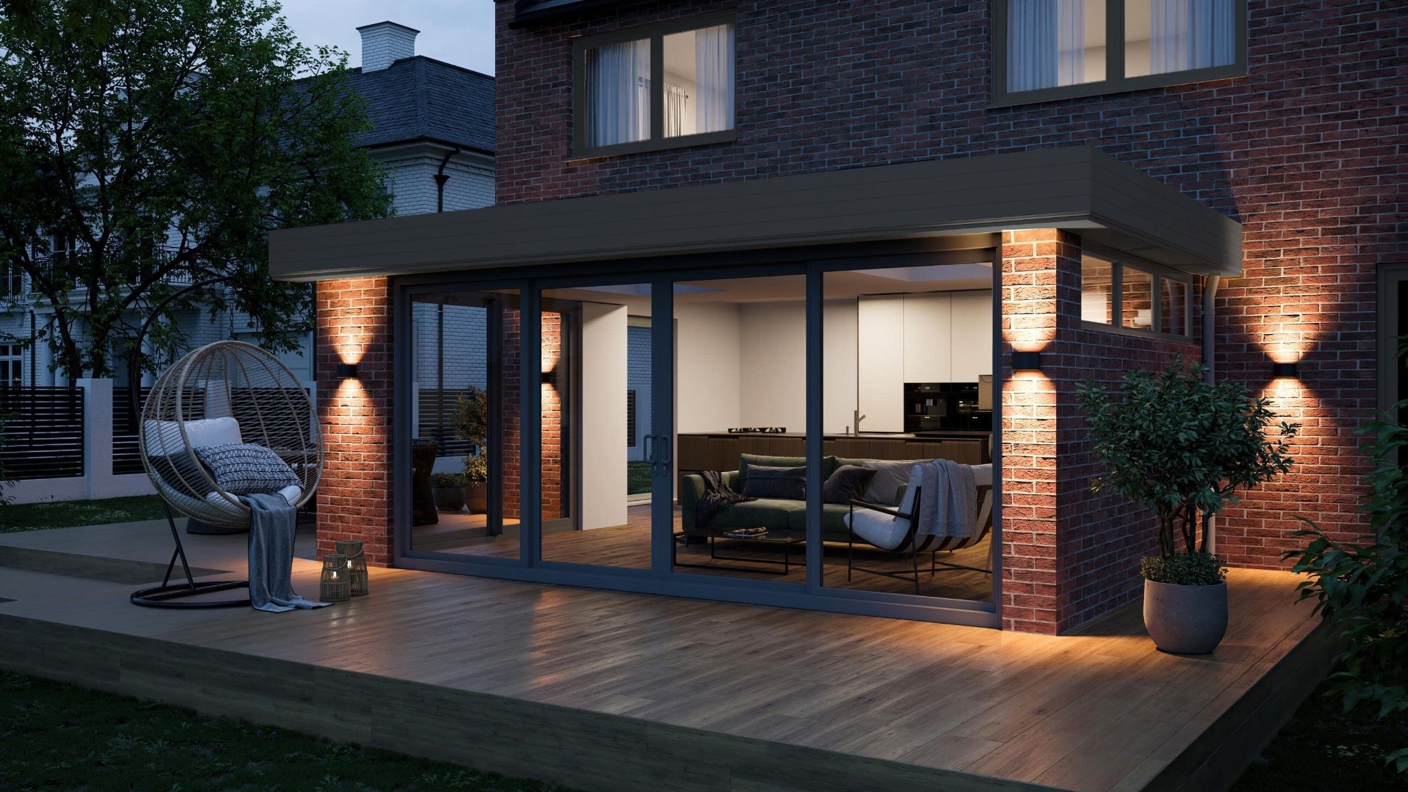 A Birmingham home with flat roofs by Ultraframe at night.